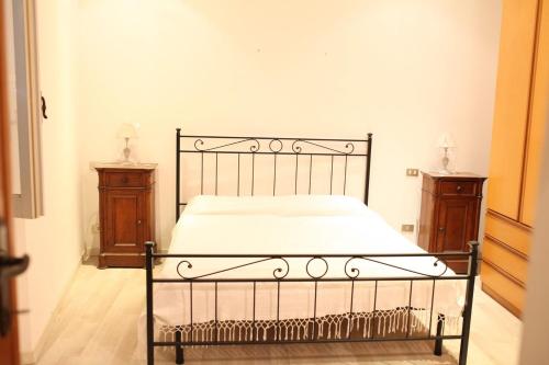 a bed in a bedroom with two night stands at la casa nell'acropoli , primo piano in Arpino