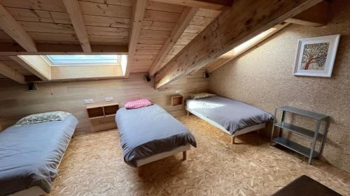 a room with two beds and a window at Haixpia, le dortoir in Hasparren