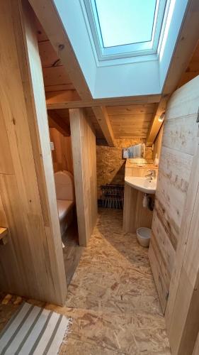 a bathroom with a skylight and a sink at Haixpia, le dortoir in Hasparren
