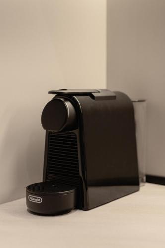 a black microwave sitting on top of a counter at Sola District Volos in Volos