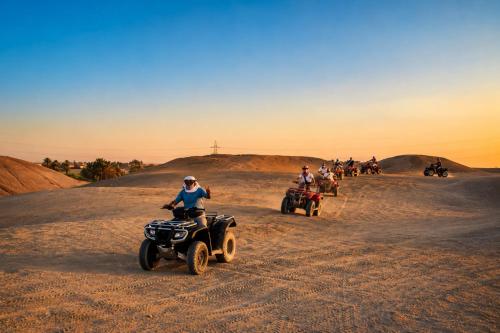 a group of people riding atvs in the desert at Luxor Star ATV in Luxor