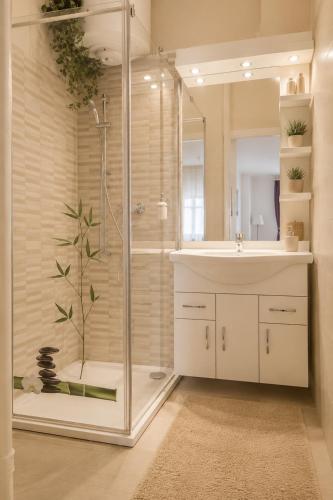 a bathroom with a shower and a sink and a sink at Andy's Home Central Apatment in Budapest