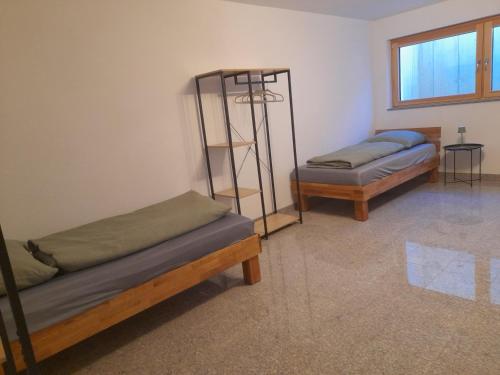 a room with two bunk beds and a shelf at Ferienhaus Traumblick-Neustadt in Neustadt an der Weinstraße