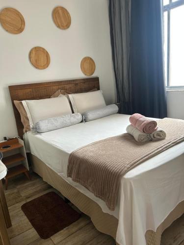 a bedroom with a bed with two towels on it at Proximo a Ipanema e Arpoador,confortavel e util! in Rio de Janeiro