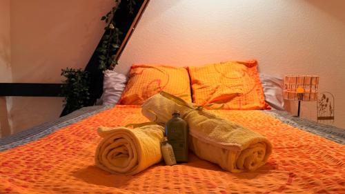 a towel and a bottle on a bed at Golden Boutique in Basel
