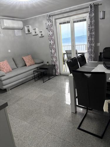 a living room with a couch and a table at Matea in Plomin