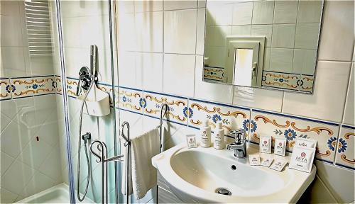 a bathroom with a sink and a shower at Maison La Torretta in Vico Equense
