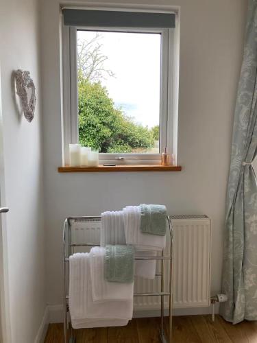 a towel rack in a bathroom with a window at Hawk Hill in Rosemarkie