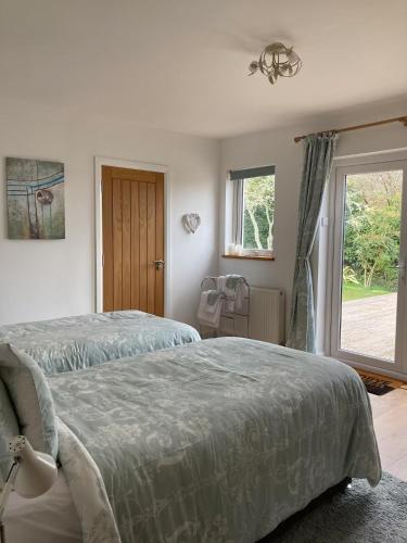 a bedroom with two beds and a window at Hawk Hill in Rosemarkie