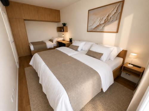 a hotel room with a large bed and two beds at Sleep & coffee by KAFEC in Komárov