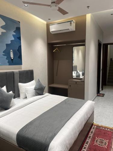 a bedroom with a large bed and a mirror at Hotel route 54 in Bathinda