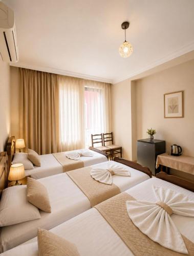 a hotel room with four beds in a room at APART HOTEL KOBULETi in Kobuleti