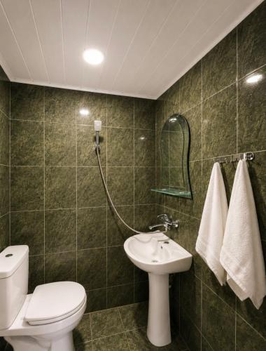 a bathroom with a toilet and a sink at APART HOTEL KOBULETi in Kobuleti