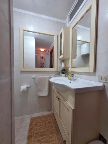 a bathroom with a sink and a mirror at La casa di Claudia Torre Suda in Torre Suda