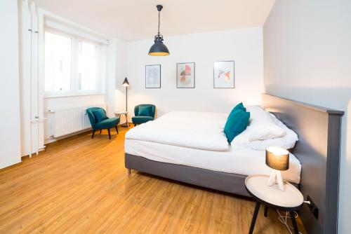 a bedroom with a bed and a table with a lamp at BENSIMON apartments Mitte - Moabit in Berlin