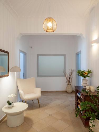 a living room with a chair and a table at Galini Rooms in Naousa