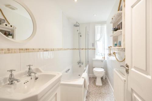 a bathroom with a sink and a toilet and a mirror at 2 Bed in Woolacombe oc-shore1 in Woolacombe