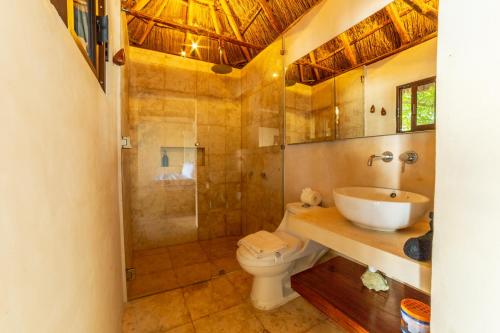 a bathroom with a toilet and a sink and a shower at Yayum Bacalar in Bacalar