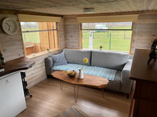 a living room with a couch and a table at Chatka u Radka in Radacz