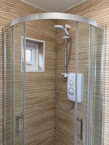 a shower with a shower head in a bathroom at Olive Mae - Cosy Room with private en-suite bathroom in Blackwood