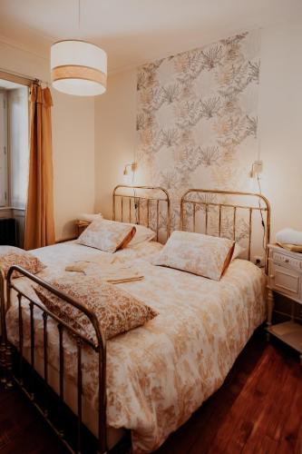 a bedroom with two beds and a wall at L' Ecrin de Suzanne-Maison de 180M2 avec sauna et bain nordique privatifs in Ray-sur-Saône