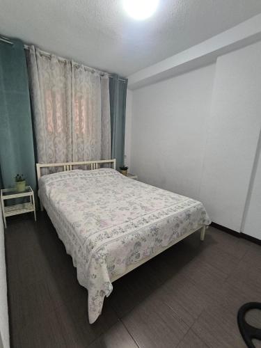 a bedroom with a bed in a room with curtains at Garden City apartment Costa Adeje in Costa de Adeje