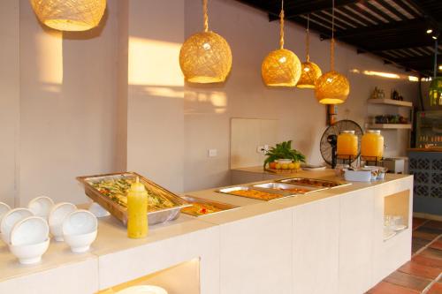 a kitchen with some food on a counter with lights at Hotel Rodadero Beach Blue in Santa Marta