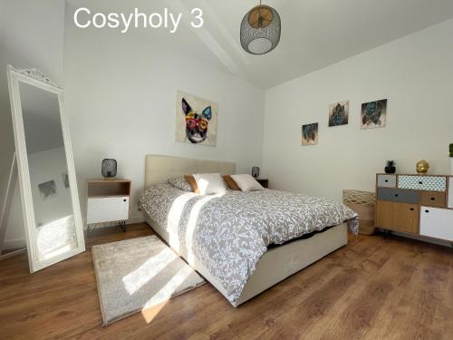 a bedroom with a bed and a dresser and a mirror at Cosyholy in Vitry-sur-Seine
