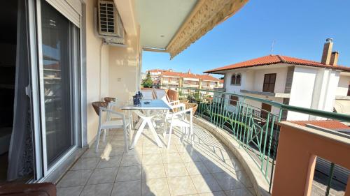 a balcony with a table and chairs on it at Keremidis Apartment in Flogita