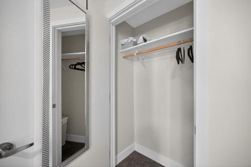 a mirror in a bathroom next to a closet at Sleek 2BR apartment in prime location in Reading