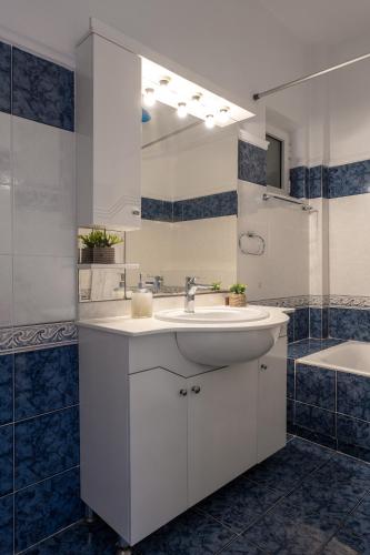 a bathroom with a sink and a mirror and a tub at The Dream Hotel in Tragaki