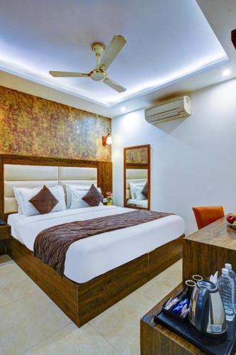 a bedroom with a large bed in a room at The Nirvana Delhi Airport - FREE Airport Drop in New Delhi
