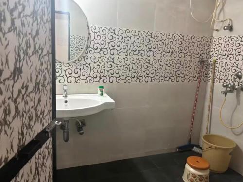 a bathroom with a sink and a mirror at 400 m from thE beach 1bhk in Colva