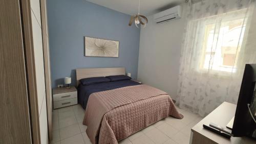 a small bedroom with a bed and a window at Viben House in Gallipoli