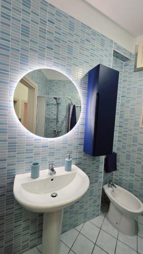 a bathroom with a sink and a mirror and a toilet at Viben House in Gallipoli