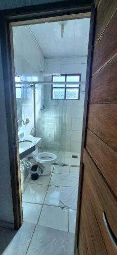 a bathroom with a toilet and a sink at Pousada Chafariz in Pirenópolis