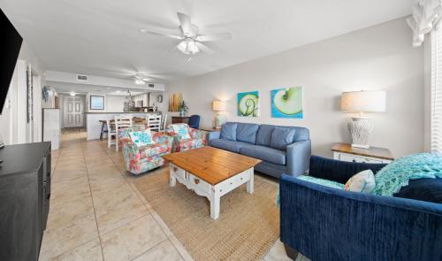 a living room with blue couches and a table at Edgewater Condo Unit #304 in South Padre Island