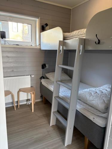 a room with two bunk beds and a table at Panorama 3 Kungsberget in Järbo
