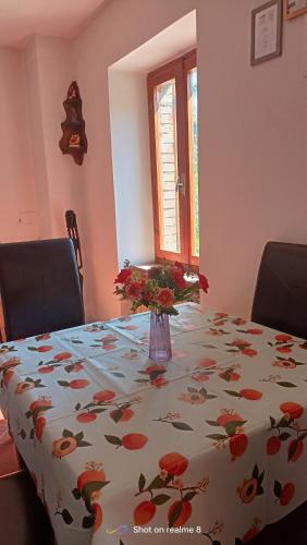 a table with a vase of flowers on top of it at Da Carlo in Pietralunga