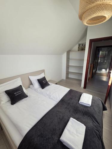 a bedroom with a large bed with two pillows at MB House Sarbinowo in Sarbinowo