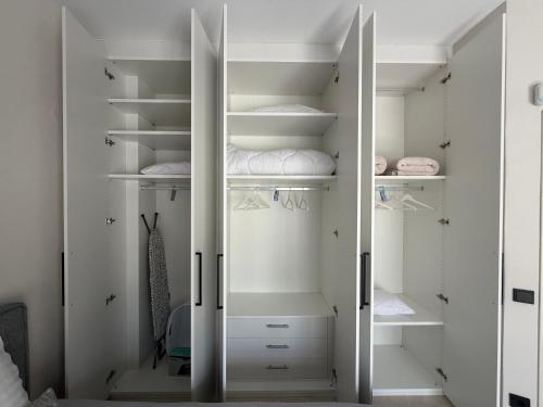 a walk in closet with white doors and shelves at The Mulberry House Heritage by the Sea in Alexandroupoli