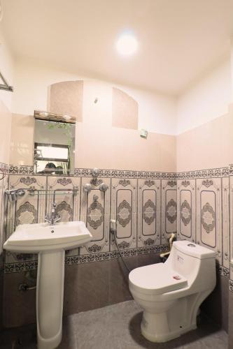 a bathroom with a toilet and a sink at Hotel Pun Inn Kathmandu in Kathmandu