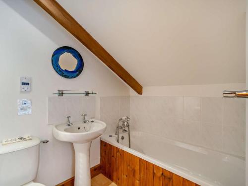 a bathroom with a sink and a toilet and a bath tub at 3 Bed in Langport oc-76372 in Drayton