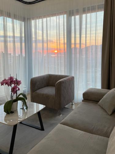a living room with a couch and a table at JoHa Stay in Bar