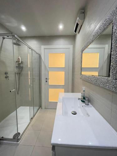 a bathroom with a shower and a sink and a mirror at sliema promenade in Sliema