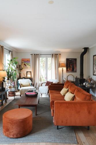 a living room with two couches and a table at Chambre avec Piscine Maison EtxeCosy in Bidart