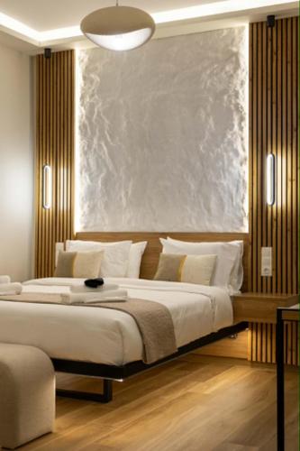 a bedroom with a large bed with white pillows at Charma Urban Living in Bendevís