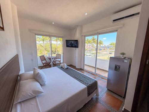 a bedroom with a bed and a sliding glass door at Lofts Terra Nuevo Vallarta in Nuevo Vallarta