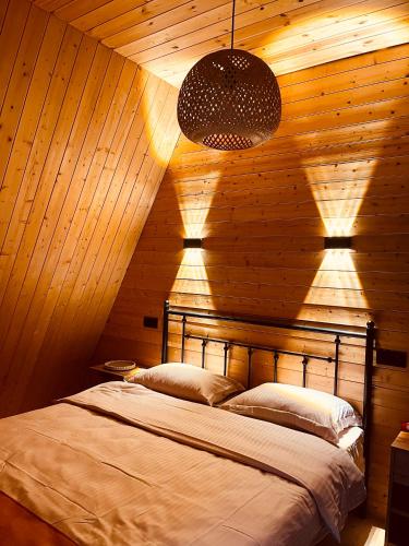 a bedroom with a bed in a wooden wall at Mtis Racha in Oni