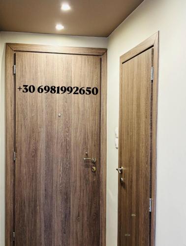a wooden door with a sign on it in a room at Downtown Studio 31 in Serres
